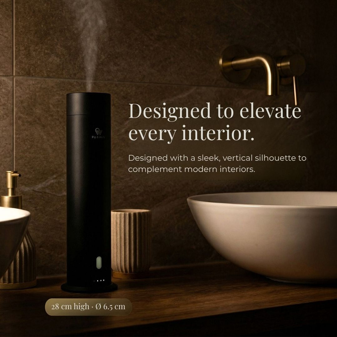 Black aroma diffuser device on a bathroom counter with text about interior design.